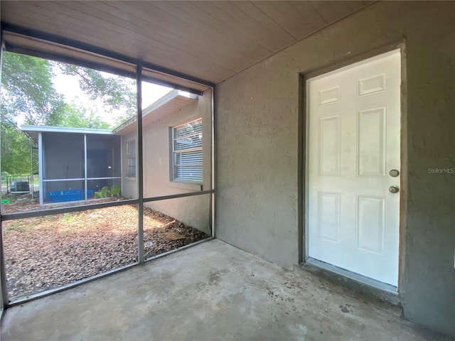 unfurnished sunroom featuring wood ceiling