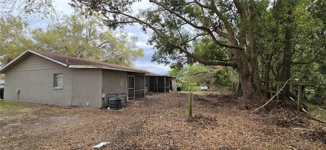 view of side of home featuring a sunroom