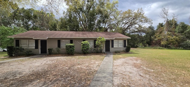 ranch-style house with a front yard and stucco siding