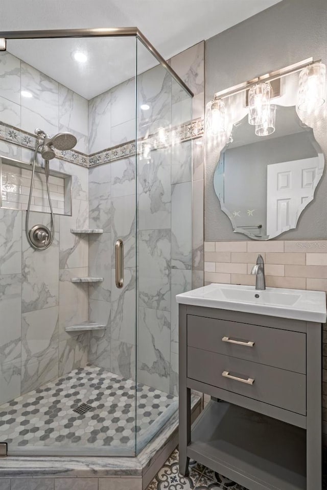 bathroom with a stall shower and vanity