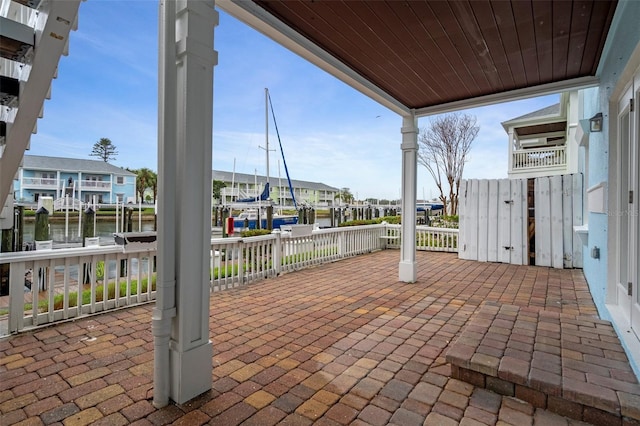 view of patio with a water view and a residential view