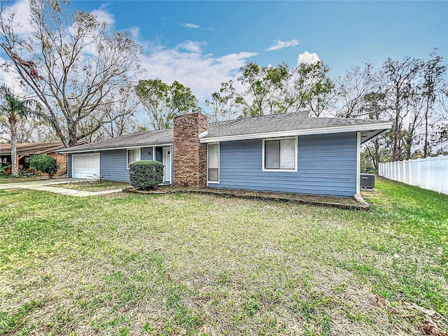 single story home with a garage, fence, a front lawn, and central AC