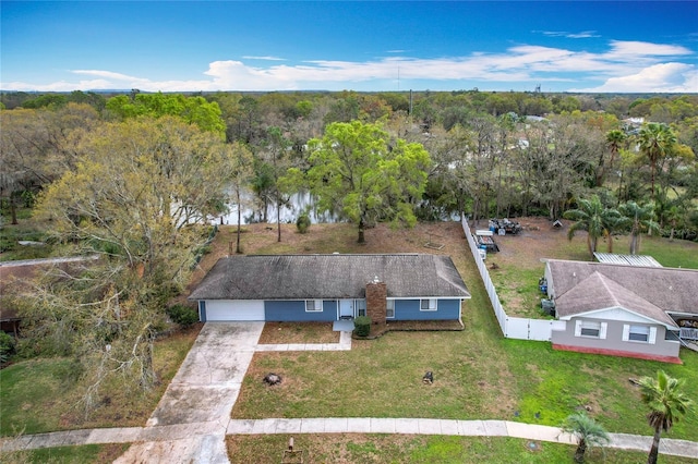 birds eye view of property featuring a view of trees