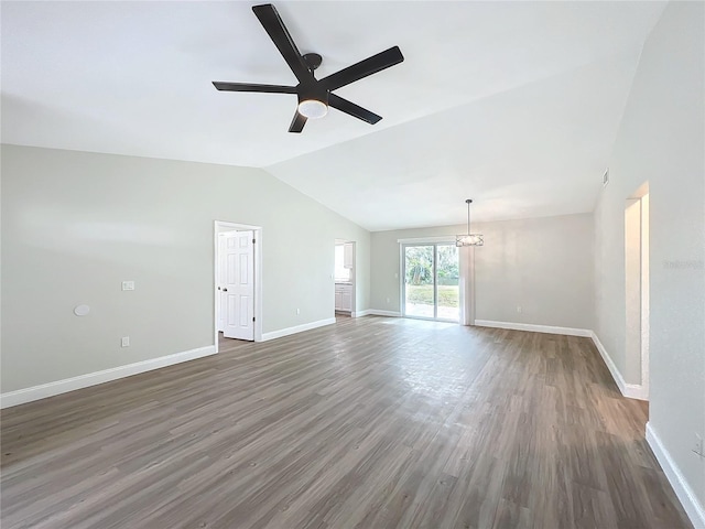 unfurnished living room with lofted ceiling, wood finished floors, a ceiling fan, and baseboards