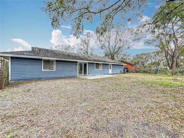 back of house featuring a yard, fence, and a patio