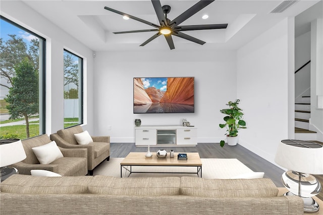 living area featuring recessed lighting, visible vents, stairway, wood finished floors, and baseboards