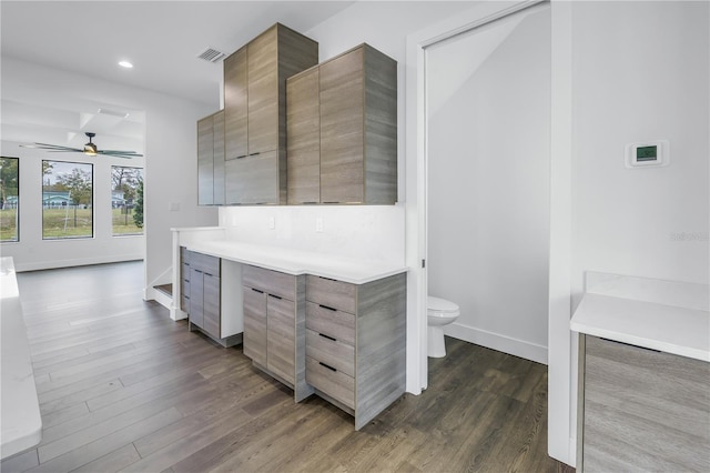 full bathroom featuring baseboards, visible vents, toilet, wood finished floors, and vanity