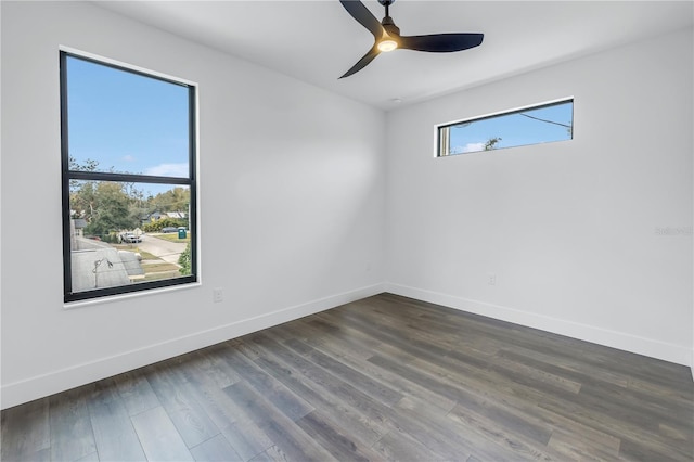 unfurnished room featuring ceiling fan, baseboards, and dark wood-type flooring