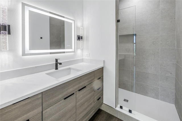 bathroom featuring a stall shower and vanity