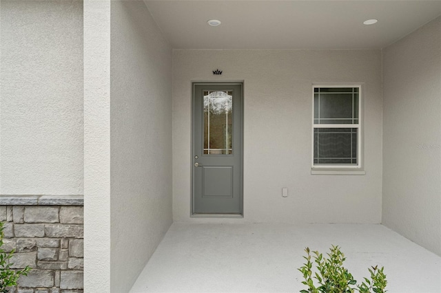 entrance to property with stucco siding