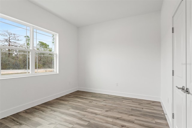 unfurnished bedroom with light wood-type flooring and baseboards