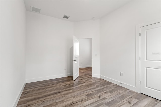 unfurnished bedroom with baseboards, visible vents, and light wood-style floors