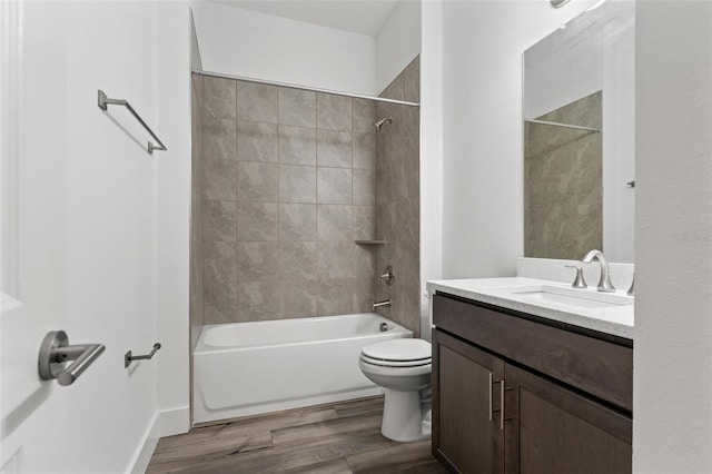 bathroom with toilet,  shower combination, wood finished floors, and vanity