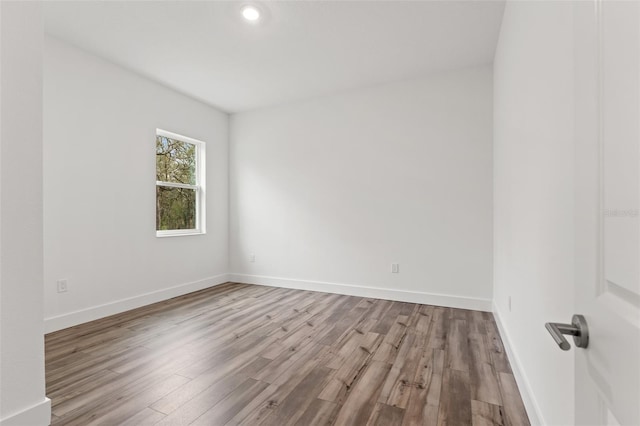 empty room featuring baseboards and light wood-style floors