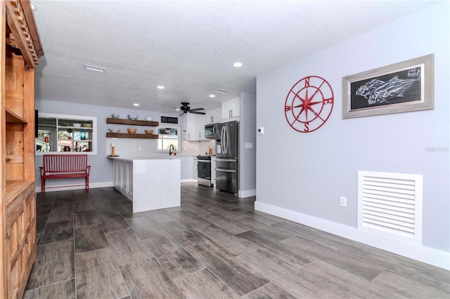 kitchen featuring visible vents, open shelves, light countertops, appliances with stainless steel finishes, and dark wood-style flooring