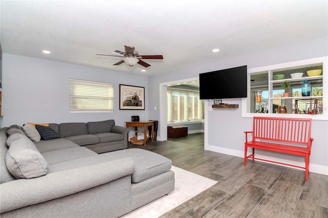 living area with a ceiling fan, recessed lighting, wood finished floors, and baseboards