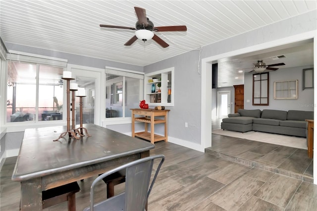 dining area with wood finish floors, visible vents, baseboards, and a ceiling fan