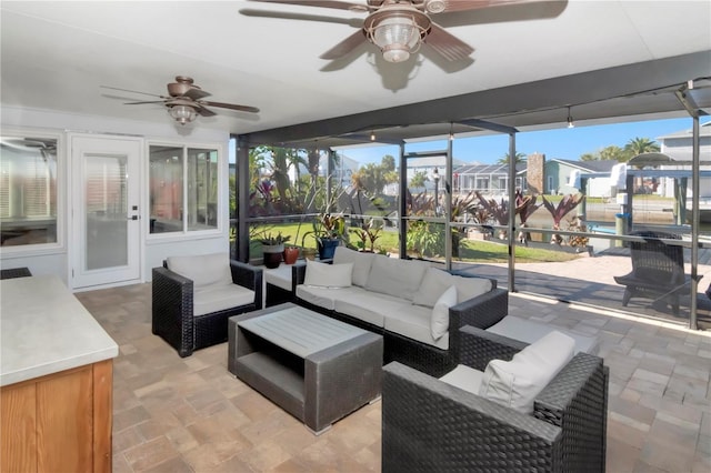 sunroom featuring ceiling fan