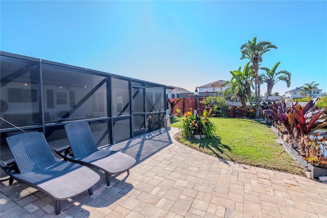 view of patio featuring a lanai and fence