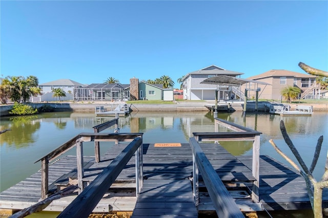 dock area with a residential view and a water view