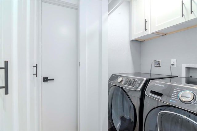 laundry area featuring cabinet space and washer and clothes dryer