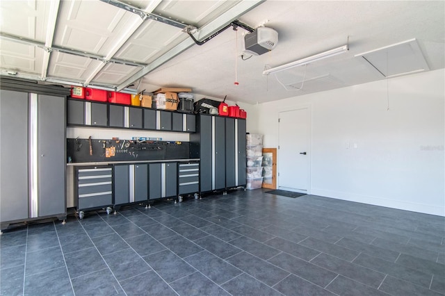 garage featuring baseboards and a garage door opener