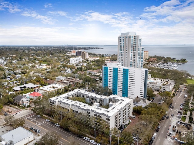 birds eye view of property with a water view and a city view