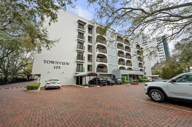 view of building exterior with uncovered parking