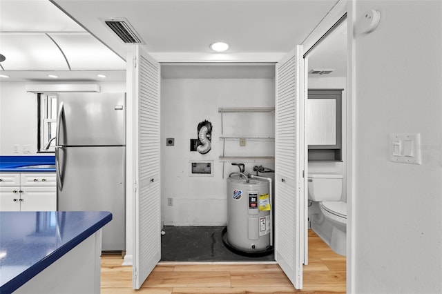 interior space with water heater and visible vents