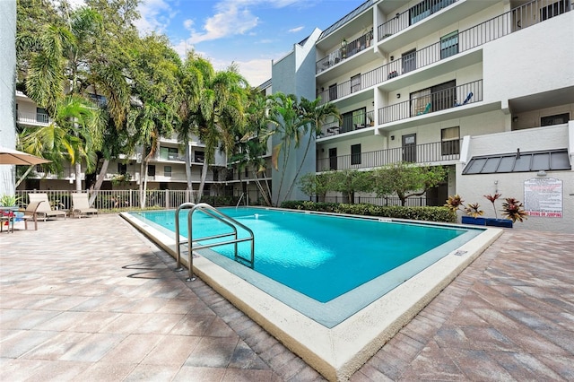 pool featuring a patio area and fence