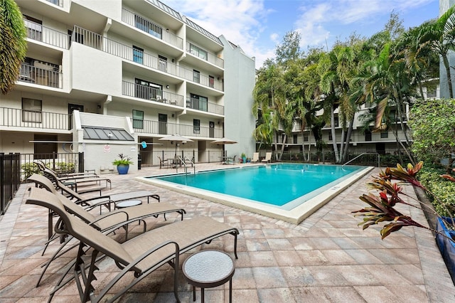 pool featuring a patio area and fence