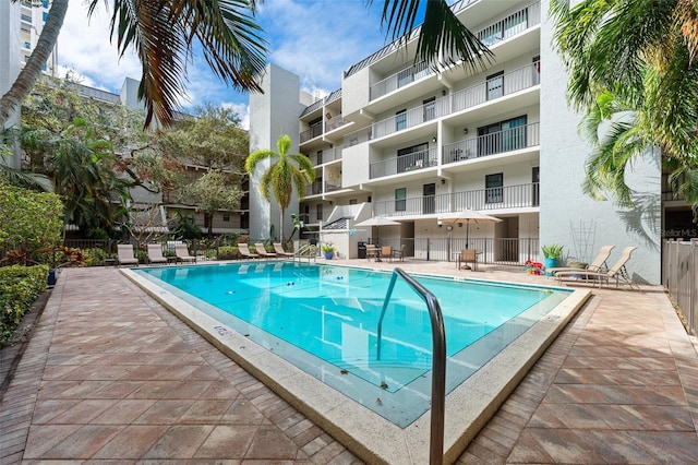 pool featuring a patio and fence