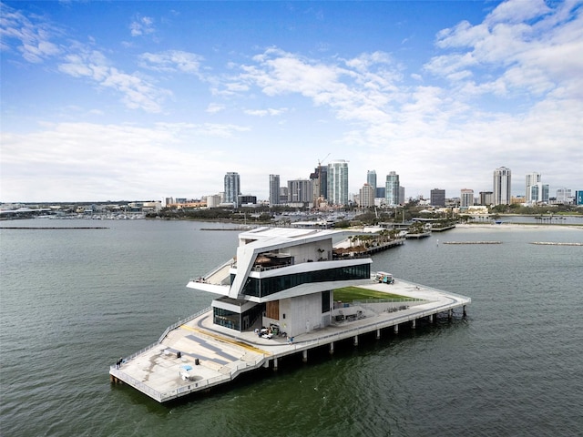 view of dock with a water view and a city view