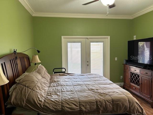 bedroom featuring access to exterior, french doors, crown molding, and ceiling fan