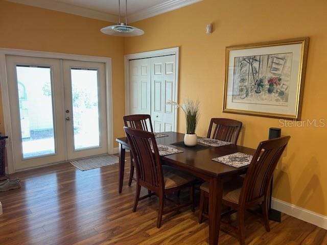 dining area with ornamental molding, french doors, baseboards, and wood finished floors