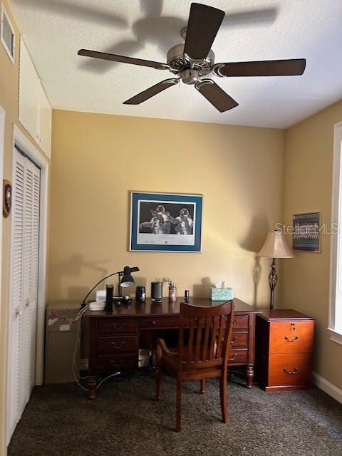 carpeted office space with visible vents and baseboards