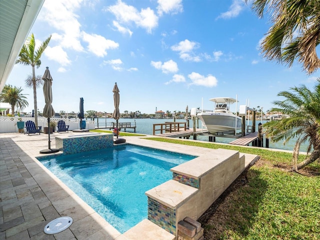 pool with a patio, boat lift, a dock, a water view, and fence