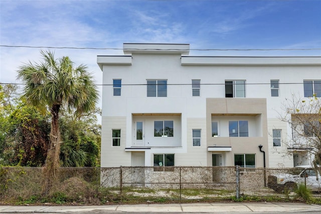 view of front facade with a fenced front yard and stucco siding