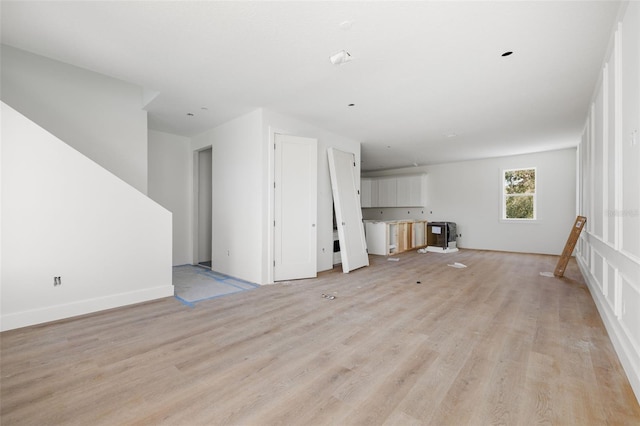 unfurnished living room with light wood finished floors