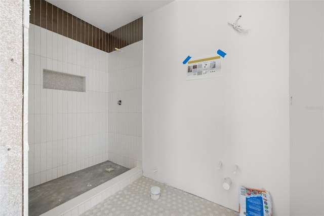 bathroom with a tile shower