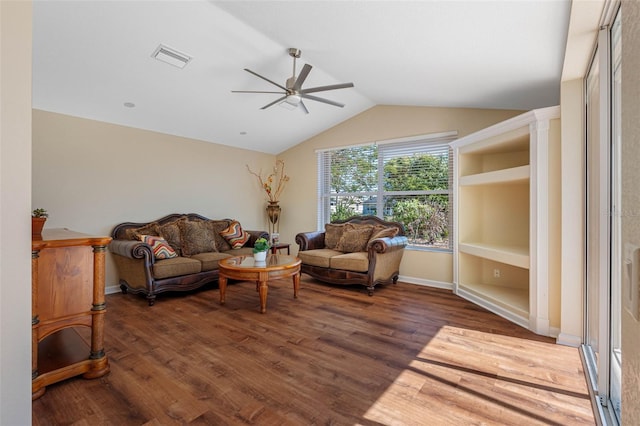 living area with a ceiling fan, visible vents, vaulted ceiling, and wood finished floors