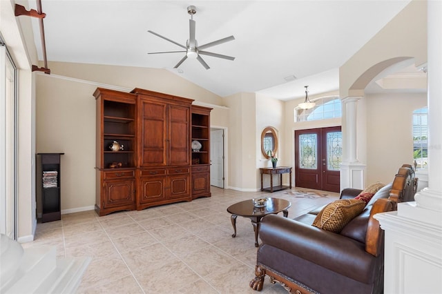 living area with arched walkways, a healthy amount of sunlight, and decorative columns