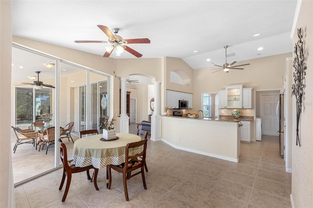 dining area with ceiling fan, light tile patterned floors, recessed lighting, vaulted ceiling, and decorative columns