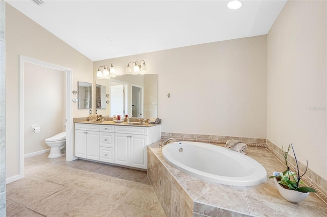 bathroom featuring double vanity, toilet, a bath, lofted ceiling, and a sink