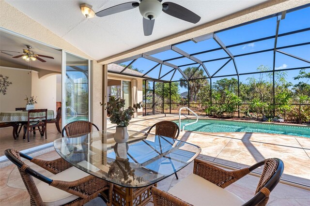 exterior space featuring ceiling fan, glass enclosure, outdoor dining space, and an outdoor pool