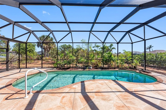 outdoor pool featuring glass enclosure and a patio