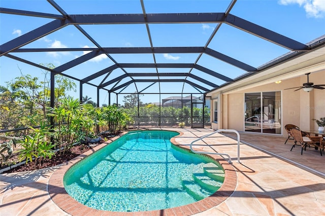 pool with a lanai, a patio area, and a ceiling fan