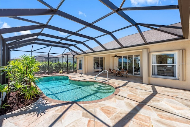 outdoor pool with a ceiling fan, a lanai, and a patio area