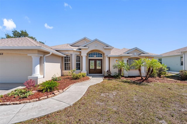 mediterranean / spanish-style home featuring a garage, french doors, a shingled roof, and stucco siding