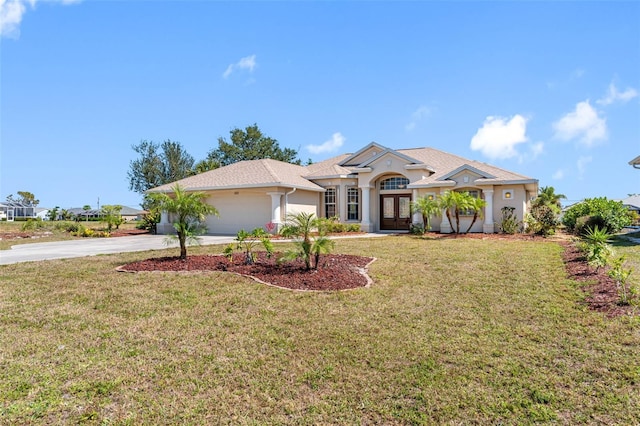 view of front of home with a garage, concrete driveway, french doors, a front lawn, and stucco siding